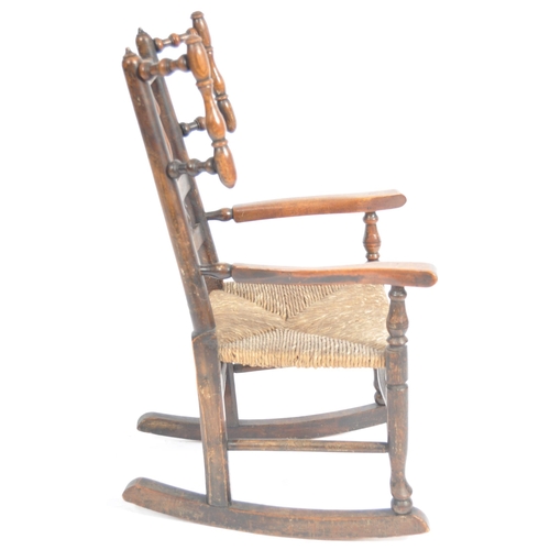 127 - A 19th Century Lancashire / North Country oak childs rocking chair with spindle back and wings havin... 