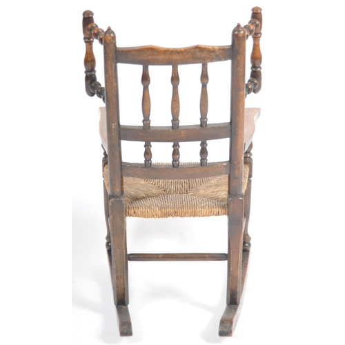 127 - A 19th Century Lancashire / North Country oak childs rocking chair with spindle back and wings havin... 