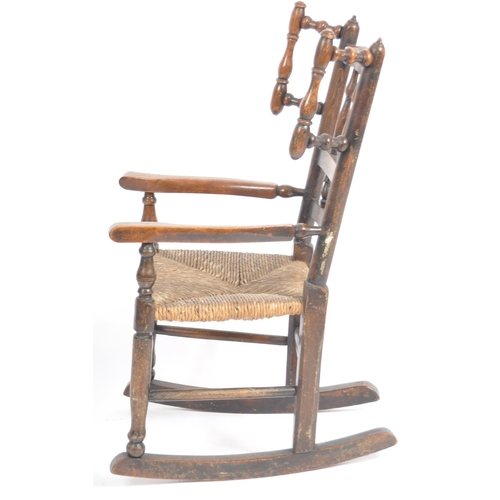 127 - A 19th Century Lancashire / North Country oak childs rocking chair with spindle back and wings havin... 