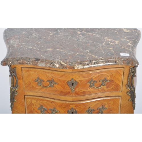 128 - A 20th Century French style walnut & marble commode chest of drawers. The bank of drawers being serp... 