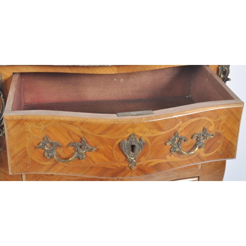 128 - A 20th Century French style walnut & marble commode chest of drawers. The bank of drawers being serp... 