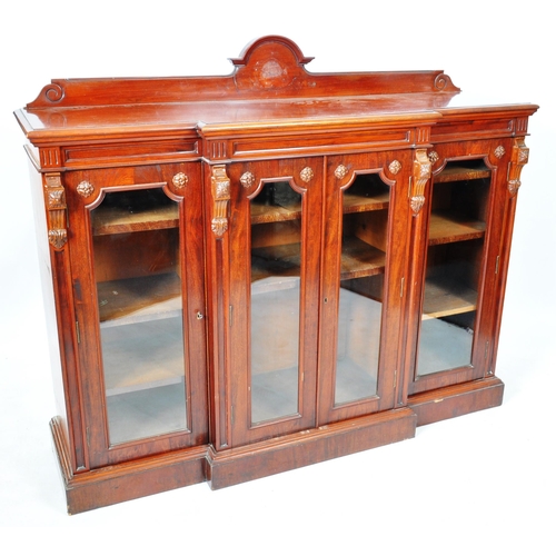 129 - An large 19th Century Victorian mahogany breakfront library bookcase cabinet having and arched back ... 