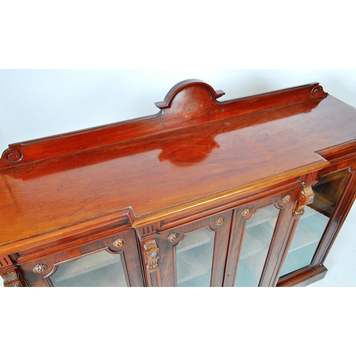 129 - An large 19th Century Victorian mahogany breakfront library bookcase cabinet having and arched back ... 