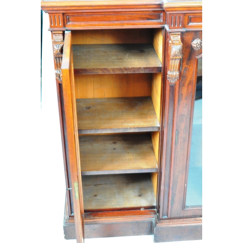 129 - An large 19th Century Victorian mahogany breakfront library bookcase cabinet having and arched back ... 