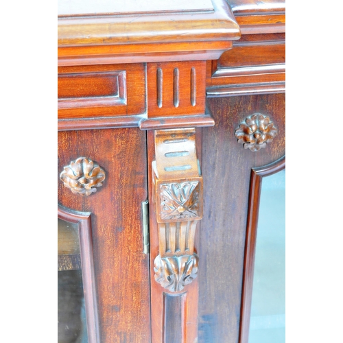 129 - An large 19th Century Victorian mahogany breakfront library bookcase cabinet having and arched back ... 