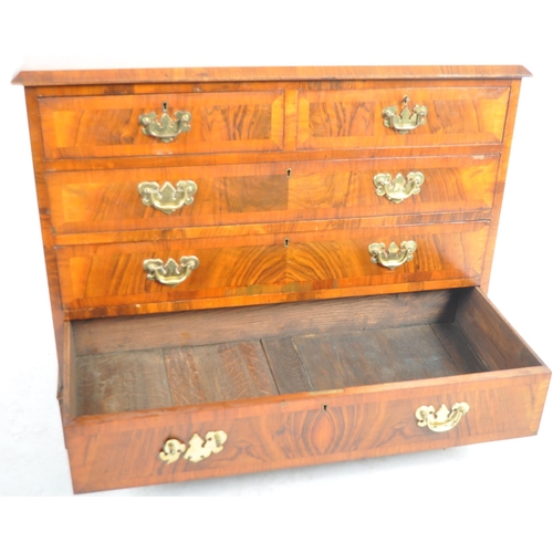 140 - A 19th Century Queen Anne revival walnut two over three chest of drawers. The bank of drawers having... 