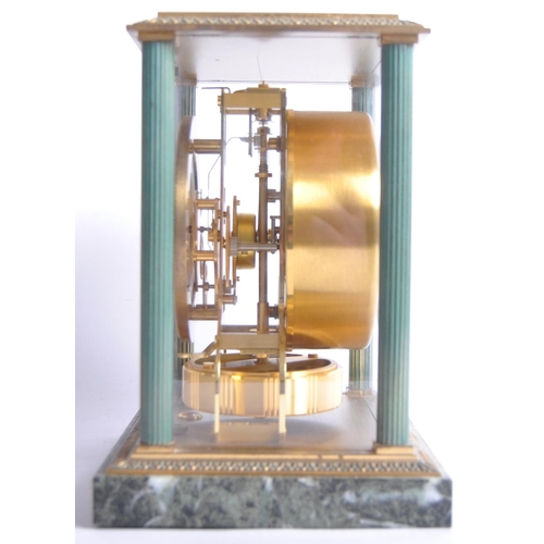 150 - A Jaeger LeCoultre Atmos clock, the glass and brass case with green enamel highlights and corner col... 