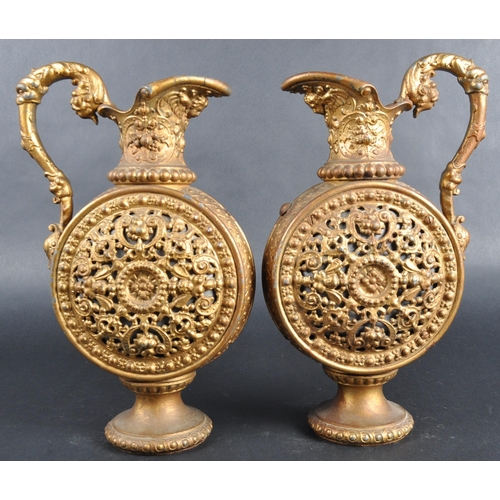 161 - A pair of early 20th Century gilt metal pilgrim flasks / ewer jugs. Lead interiors with pierced clas... 