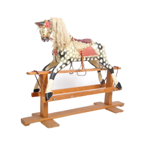 163 - A 19th Century Victorian rocking horse by Collinson. Painted black and white decoration with hair ma... 