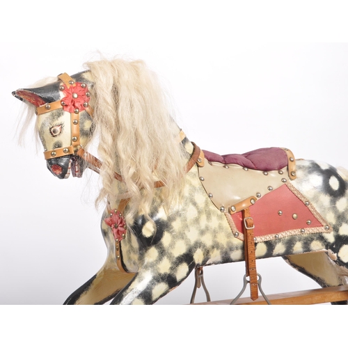 163 - A 19th Century Victorian rocking horse by Collinson. Painted black and white decoration with hair ma... 