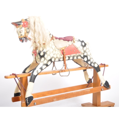 163 - A 19th Century Victorian rocking horse by Collinson. Painted black and white decoration with hair ma... 