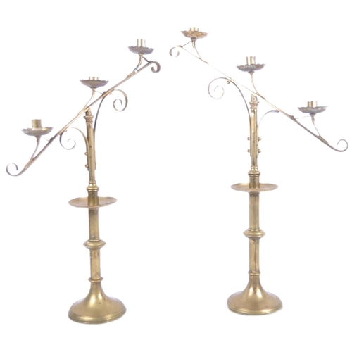 164 - A pair of 19th Century brass ecclesiastical Gothic triple sconce candlesticks / candelabra in the ma... 