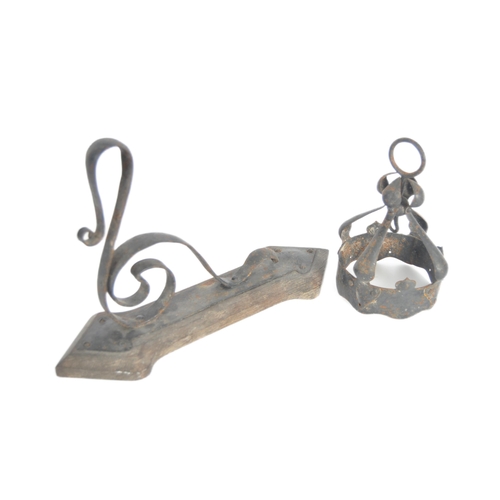 166 - A 19th Century wrought metal Arts & Crafts wrought metal wall light comprising a shaped metal wall a... 