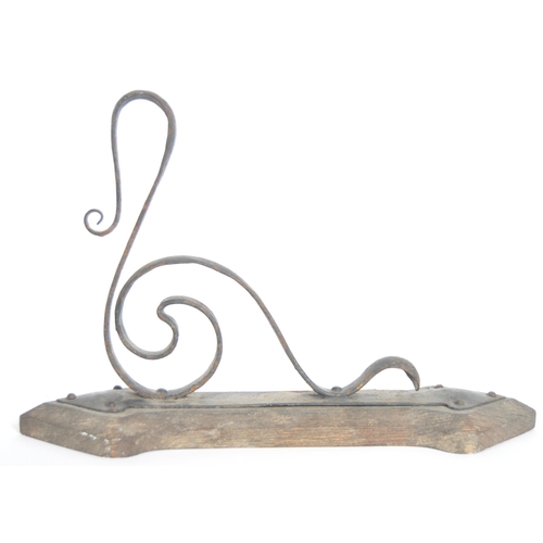 166 - A 19th Century wrought metal Arts & Crafts wrought metal wall light comprising a shaped metal wall a... 