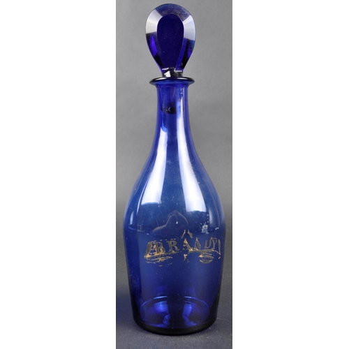 173 - A pair of early 19th Century Bristol Blue glass Indian Club shaped decanters. Gilded labels for Bran... 