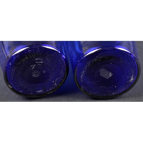 173 - A pair of early 19th Century Bristol Blue glass Indian Club shaped decanters. Gilded labels for Bran... 