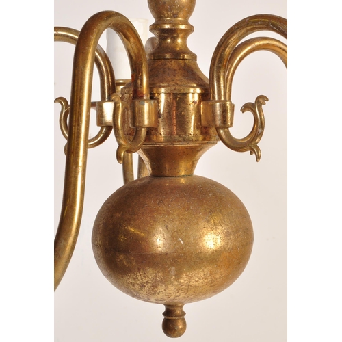 176 - A 20th Century Dutch style brass ceiling light having central bulbous stems with scrolled arms protr... 