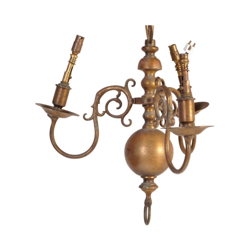 176 - A 20th Century Dutch style brass ceiling light having central bulbous stems with scrolled arms protr... 