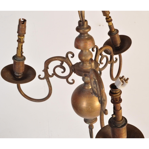 176 - A 20th Century Dutch style brass ceiling light having central bulbous stems with scrolled arms protr... 