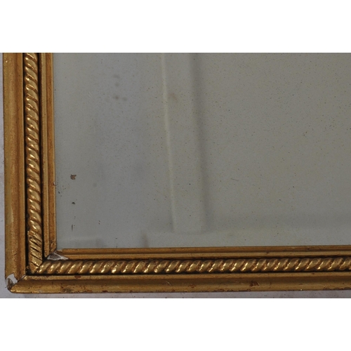 179 - An early 20tth Century gilt wall mirror of rectangular form having a rope moulded frame with inset m... 