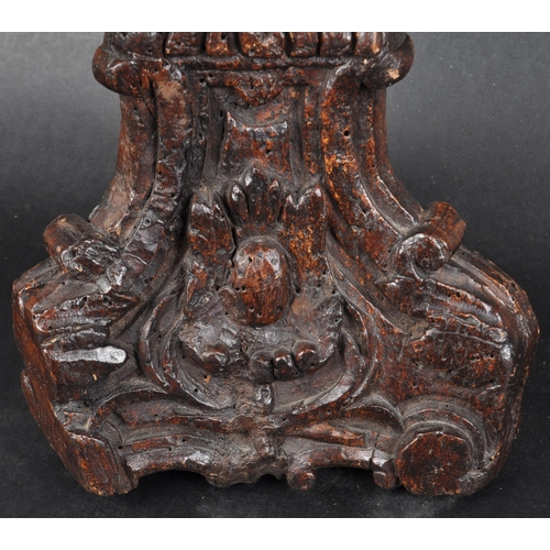 183 - An early 18th century oak carved church altar candle holder. Of triangular form, with floral and scr... 