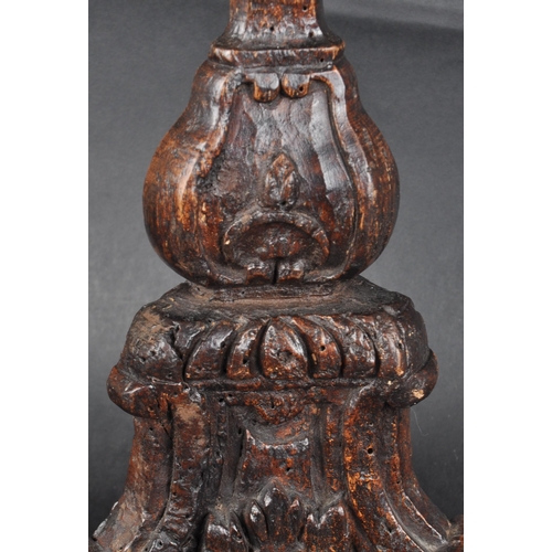 183 - An early 18th century oak carved church altar candle holder. Of triangular form, with floral and scr... 