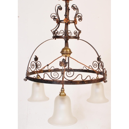 184 - An early 20th Century copper & wrought iron ceiling light lamp fixture having a scrolled frame with ... 