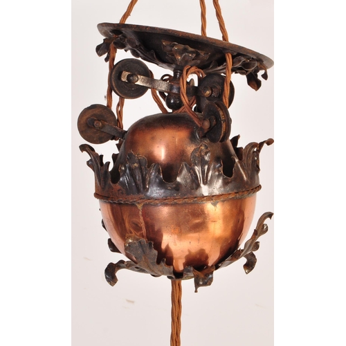 184 - An early 20th Century copper & wrought iron ceiling light lamp fixture having a scrolled frame with ... 