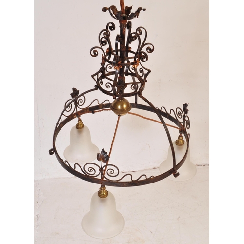 184 - An early 20th Century copper & wrought iron ceiling light lamp fixture having a scrolled frame with ... 