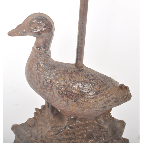 191 - A 19th Century Victorian cast iron door stop in the form of a duck with scrolled handle atop. Measur... 