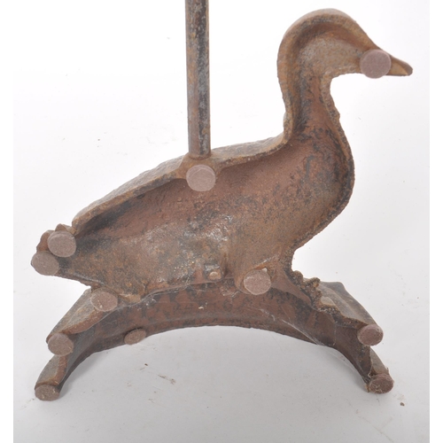 191 - A 19th Century Victorian cast iron door stop in the form of a duck with scrolled handle atop. Measur... 