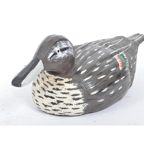 194 - A 20th Century carved wood and painted folk art decoy duck.The duck decorated in black and white wit... 