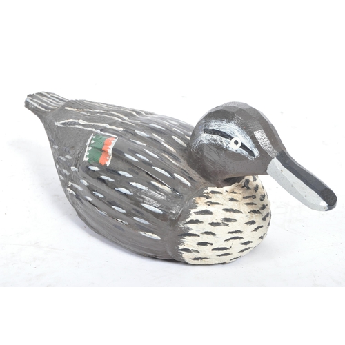 194 - A 20th Century carved wood and painted folk art decoy duck.The duck decorated in black and white wit... 