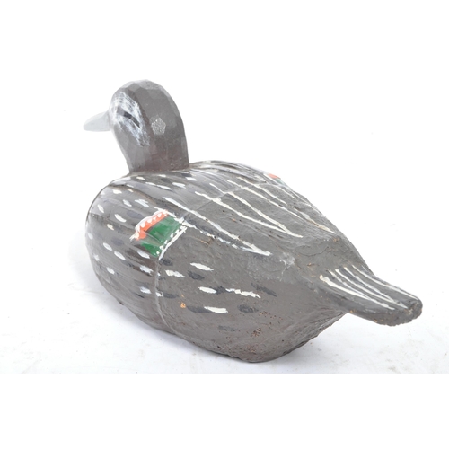 194 - A 20th Century carved wood and painted folk art decoy duck.The duck decorated in black and white wit... 