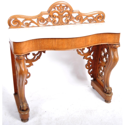 203 - A 19th Century marble topped mahogany console table having a pierced back gallery top with serpentin... 