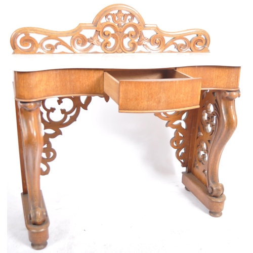 203 - A 19th Century marble topped mahogany console table having a pierced back gallery top with serpentin... 