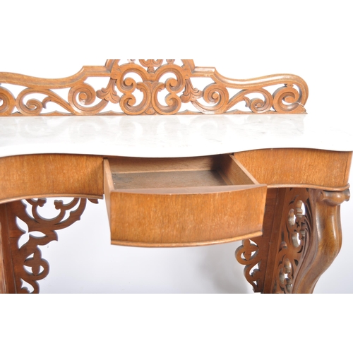 203 - A 19th Century marble topped mahogany console table having a pierced back gallery top with serpentin... 