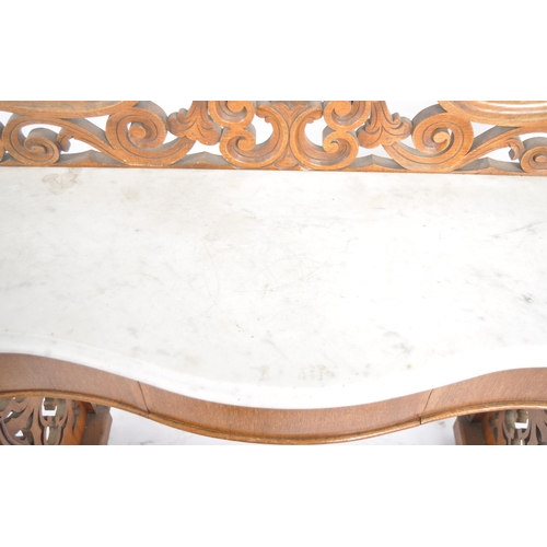 203 - A 19th Century marble topped mahogany console table having a pierced back gallery top with serpentin... 