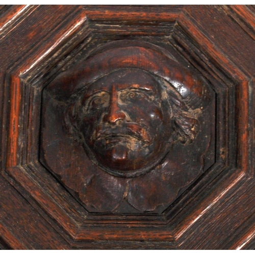 207 - A pair of 19th Century carved oak panel doors of geometric form. Central carved face with intricate ... 