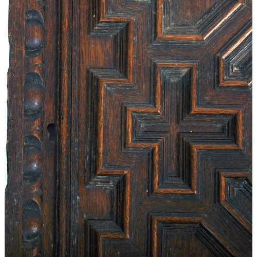 207 - A pair of 19th Century carved oak panel doors of geometric form. Central carved face with intricate ... 