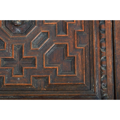 207 - A pair of 19th Century carved oak panel doors of geometric form. Central carved face with intricate ... 