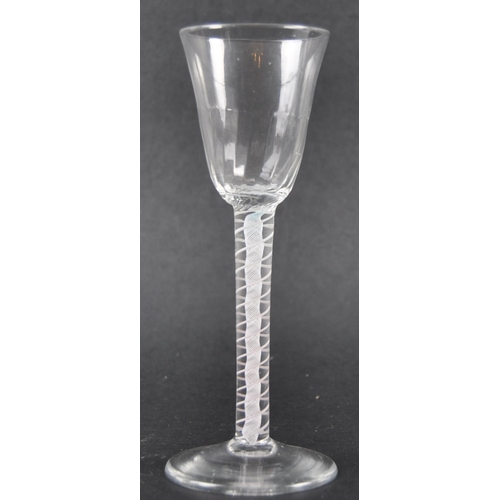 21 - An 18th Century double series opaque twist wine drinking glass having a flute moulded rounded funnel... 