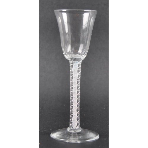 21 - An 18th Century double series opaque twist wine drinking glass having a flute moulded rounded funnel... 