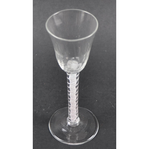 21 - An 18th Century double series opaque twist wine drinking glass having a flute moulded rounded funnel... 