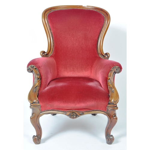 213 - A 19th Century Victorian mahogany framed library reading armchair having a carved show wood frame wi... 