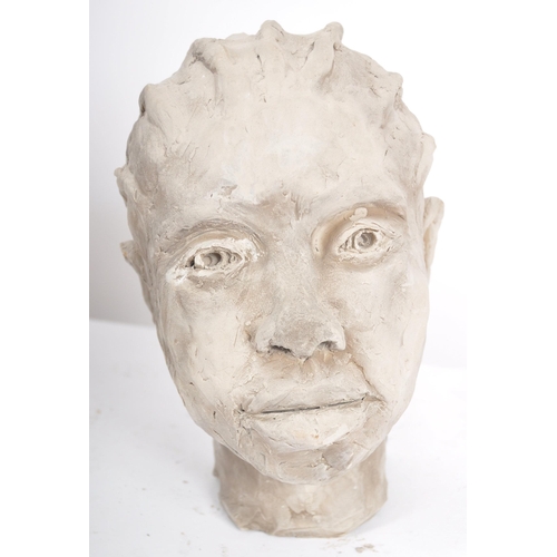 214 - A 20th Century clay sculpture portrait bust depicting an young African girl. Detailed facial feature... 