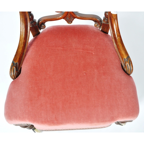 217 - A 19th Century Victorian mahogany nursing chair. The chair having a cushioned buttoned back with fre... 