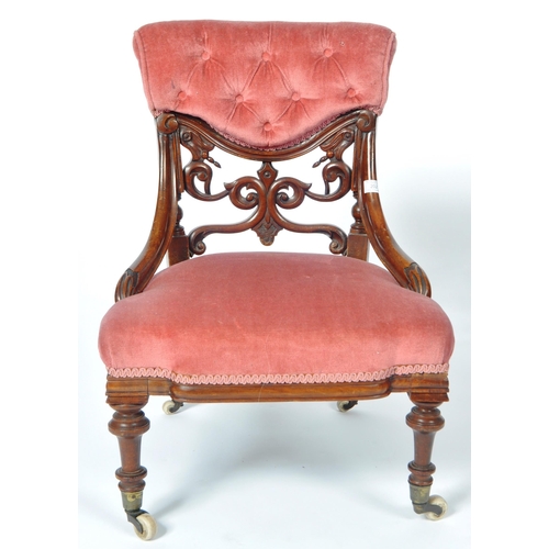 217 - A 19th Century Victorian mahogany nursing chair. The chair having a cushioned buttoned back with fre... 