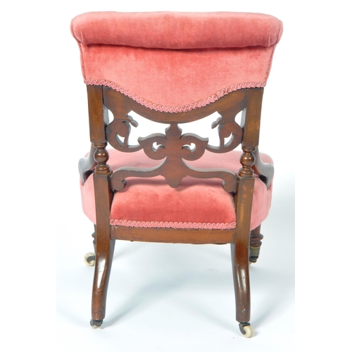 217 - A 19th Century Victorian mahogany nursing chair. The chair having a cushioned buttoned back with fre... 