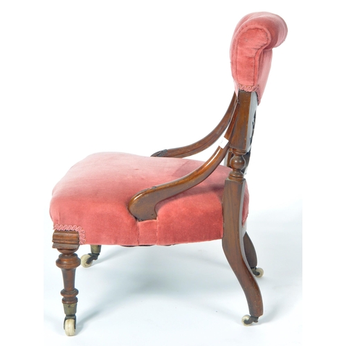 217 - A 19th Century Victorian mahogany nursing chair. The chair having a cushioned buttoned back with fre... 